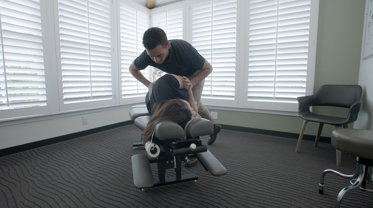 Dr. Zimmerman performing a precise spinal adjustment in our Flintridge treatment suite